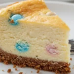 Slice of Mini Egg Cheesecake on a fork, highlighting its creamy filling and biscuit base.